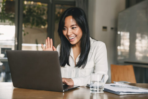 Image of happy asian woman 20s wearing white shirt smiling and w
